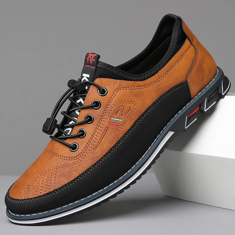 Side angle of camel brown leather lace-up shoe with black panelling and chunky rubber sole