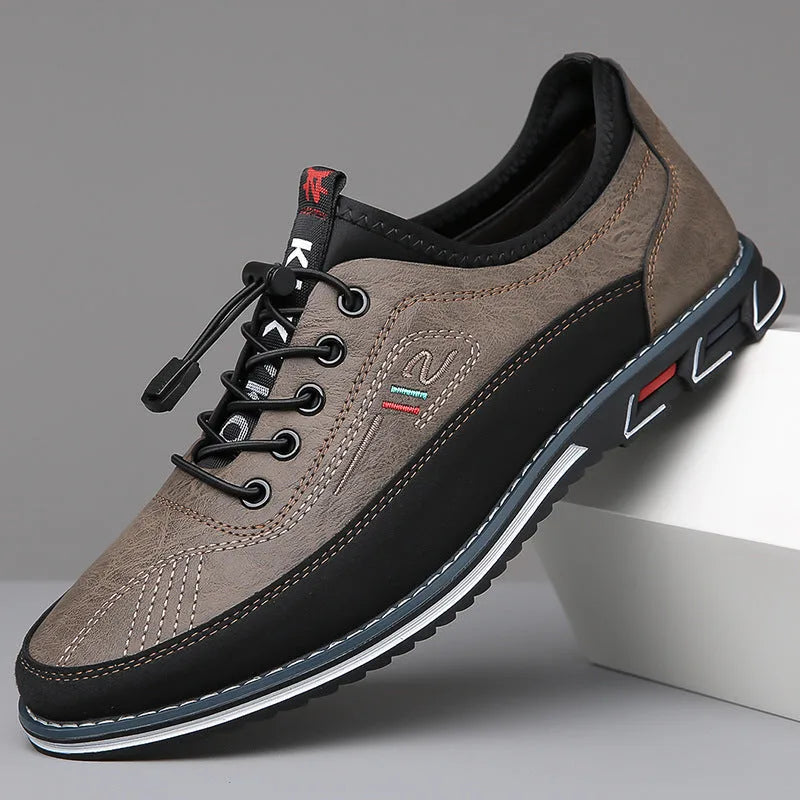 Stone grey leather shoe with black trim, elastic toggle laces and ridged outsole detail