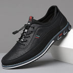 Midnight black leather shoe with black suede panel and white sole stripe, side profile