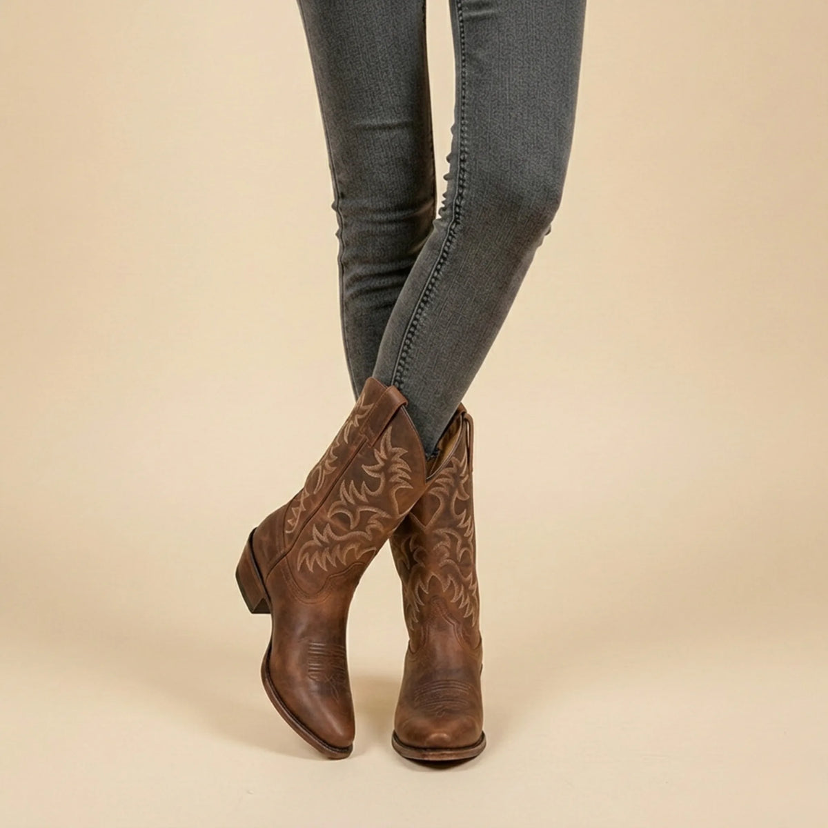 Back view of a black leather cowboy boot showing the pull strap and heel seam construction