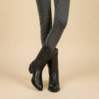 Top-down view into the black leather boot shaft revealing the lined interior and collar shape