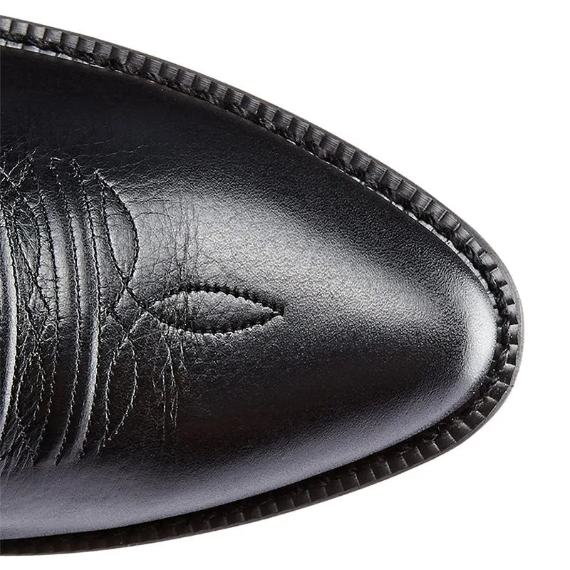 Close-up of the black leather pointed toe cap showing the smooth finish and subtle stitching