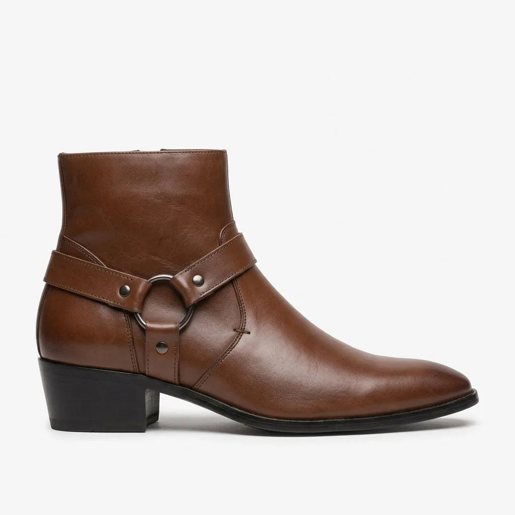 Side view of a brown leather harness boot with pointed toe, stacked block heel and metal ring detail