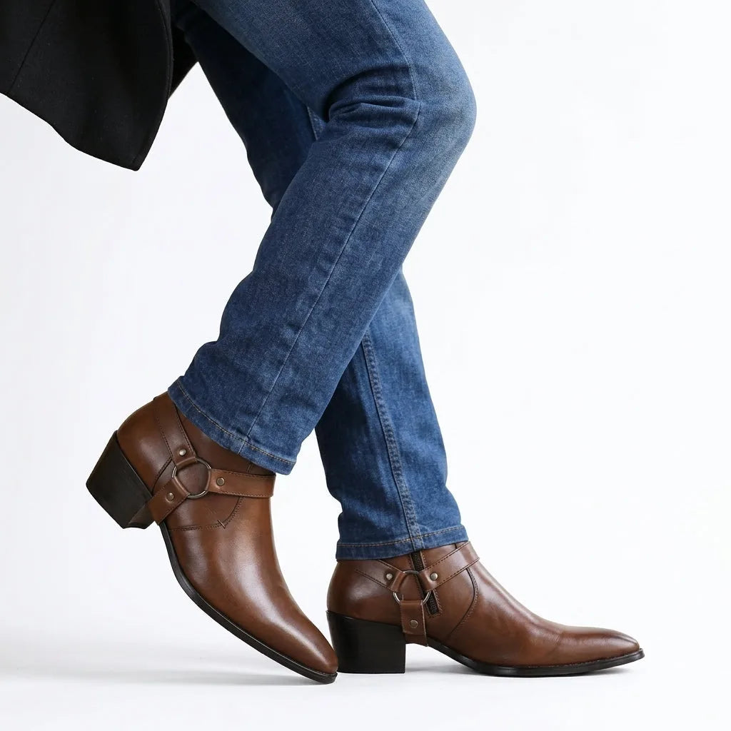 Model walking in brown leather harness boots paired with slim denim jeans