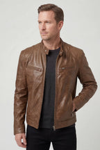 Front view of a man wearing a tan brown leather jacket with zip chest pockets and stand collar