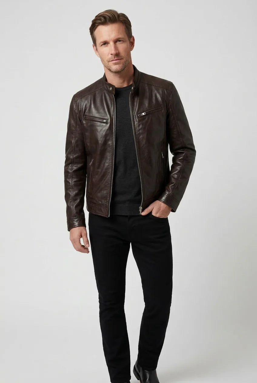 Full-length view of a man wearing a dark brown leather jacket with black trousers and boots