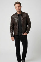 Full-length view of a man wearing a dark brown leather jacket with black trousers and boots
