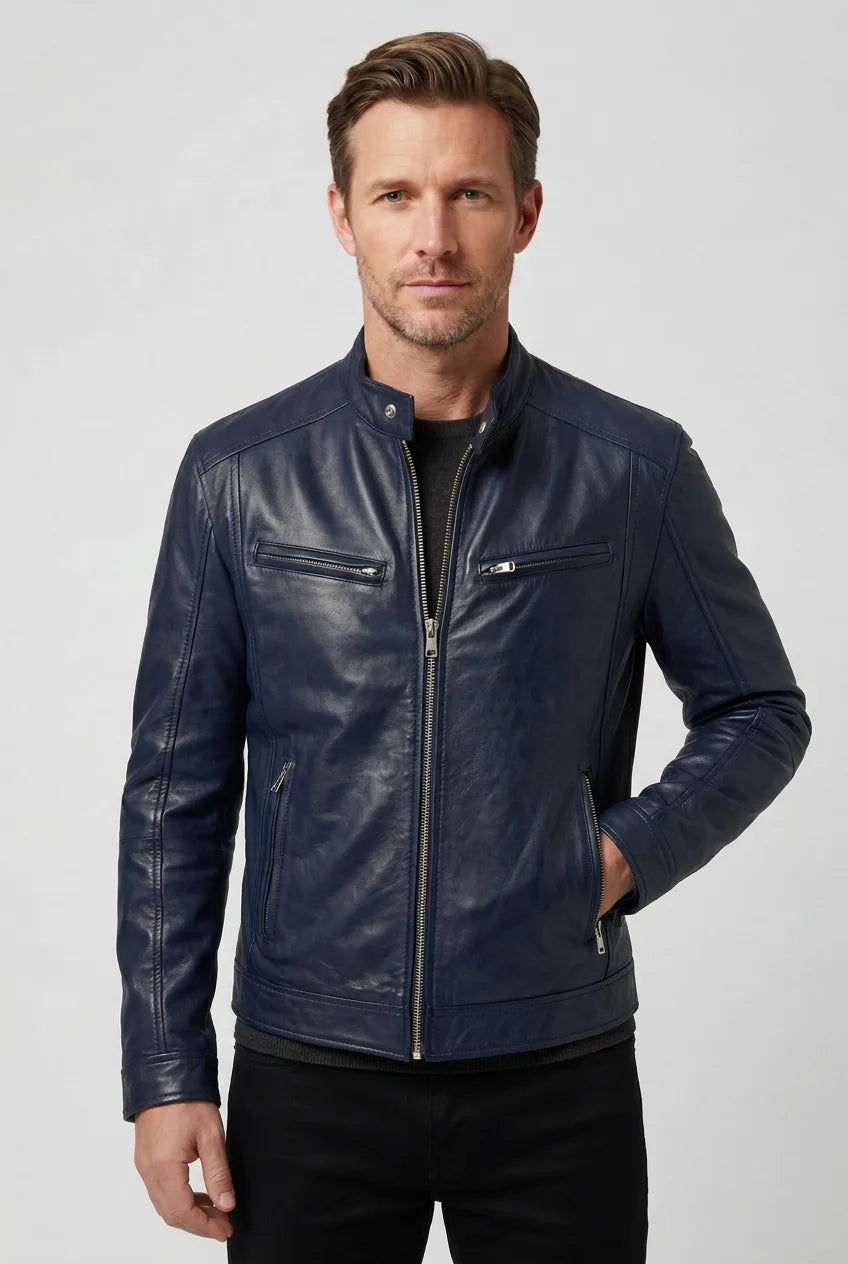 Front view of a man wearing a navy blue leather jacket with silver zip detailing and side pockets