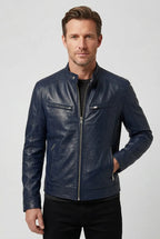 Front view of a man wearing a navy blue leather jacket with silver zip detailing and side pockets