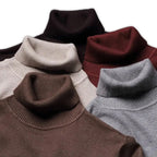 Five polo neck jumpers laid out showing the collar in brown, beige, black, burgundy and grey