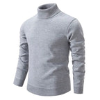 Man in a black polo neck jumper walking outdoors, three-quarter view showing fitted sleeves