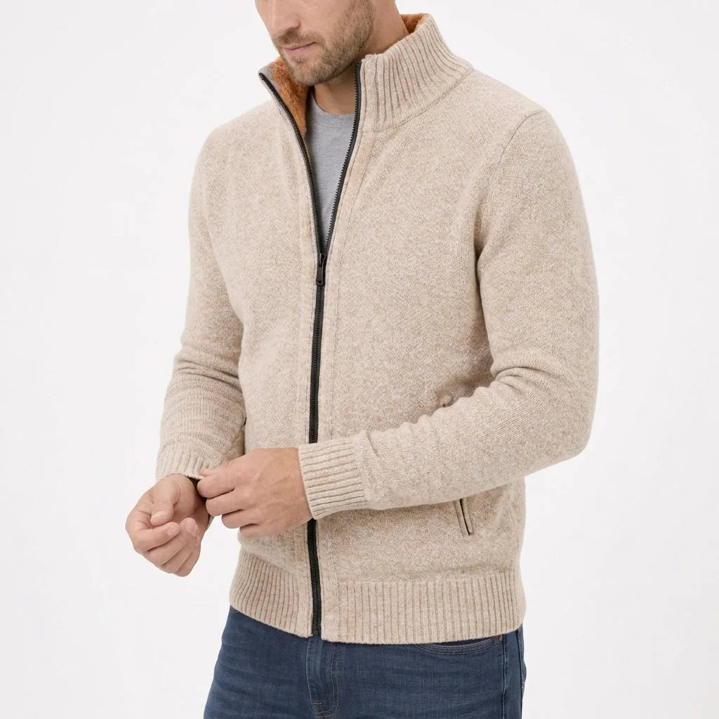 Close-up of oatmeal cream zip jumper worn half-zipped, showing textured knit and ribbed cuff detail