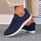 Top view of light blue knit trainers showing the wide rounded toe shape
