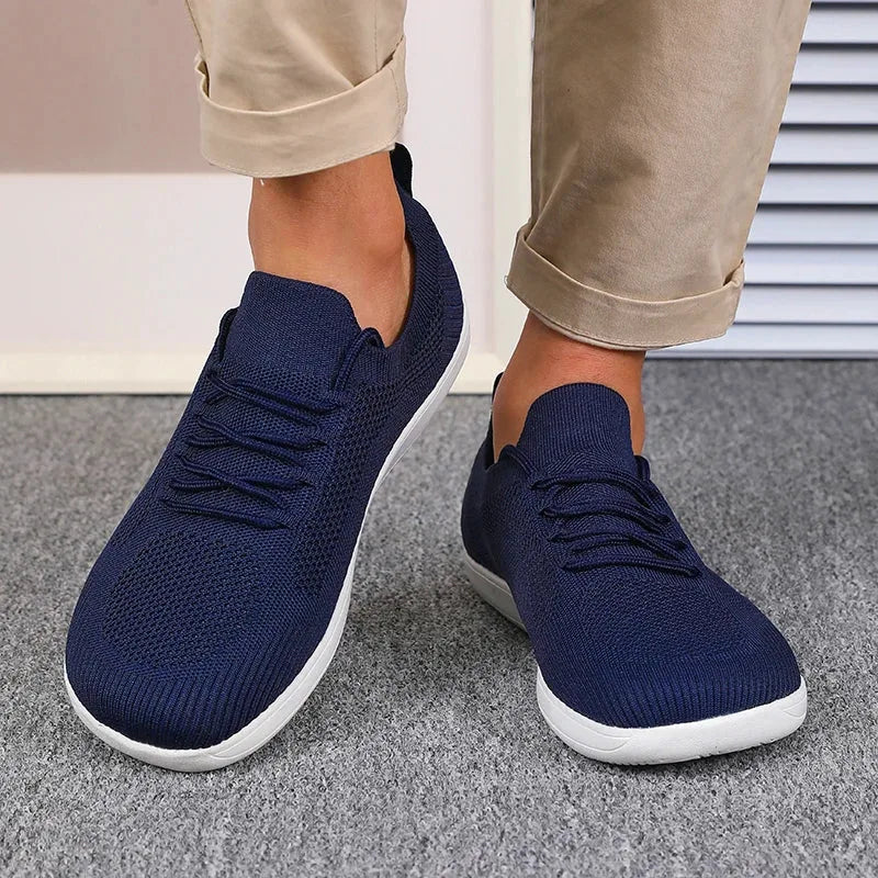 Close-up of the lace-up front and elastic knit tongue on a light blue trainer