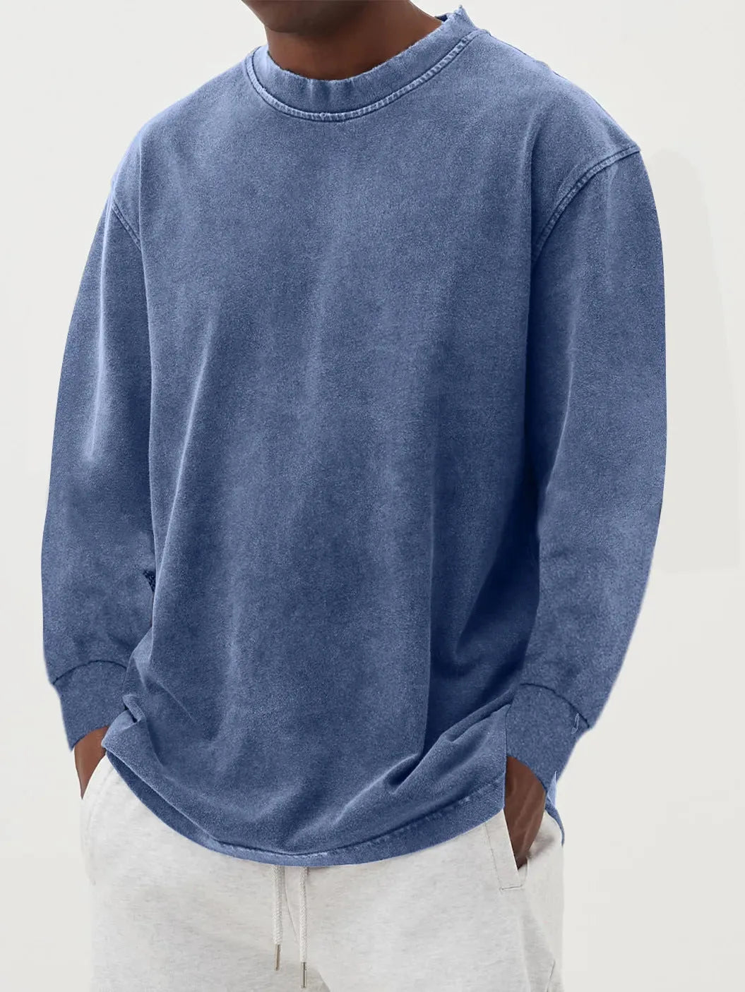 Grey washed knit jumper shown with hands in pockets, highlighting the relaxed oversized silhouette