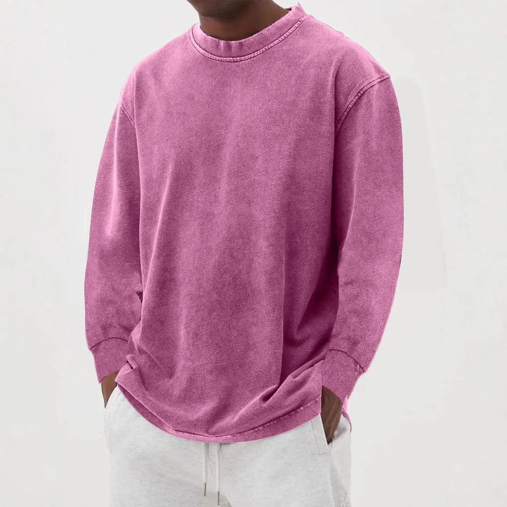 Pink washed oversized knit jumper with a round neckline and dropped shoulders, worn with light grey joggers
