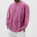 Pink washed oversized knit jumper with a round neckline and dropped shoulders, worn with light grey joggers