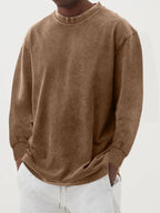 Side-angled view of the dark blue washed jumper showing the loose drape and curved hem