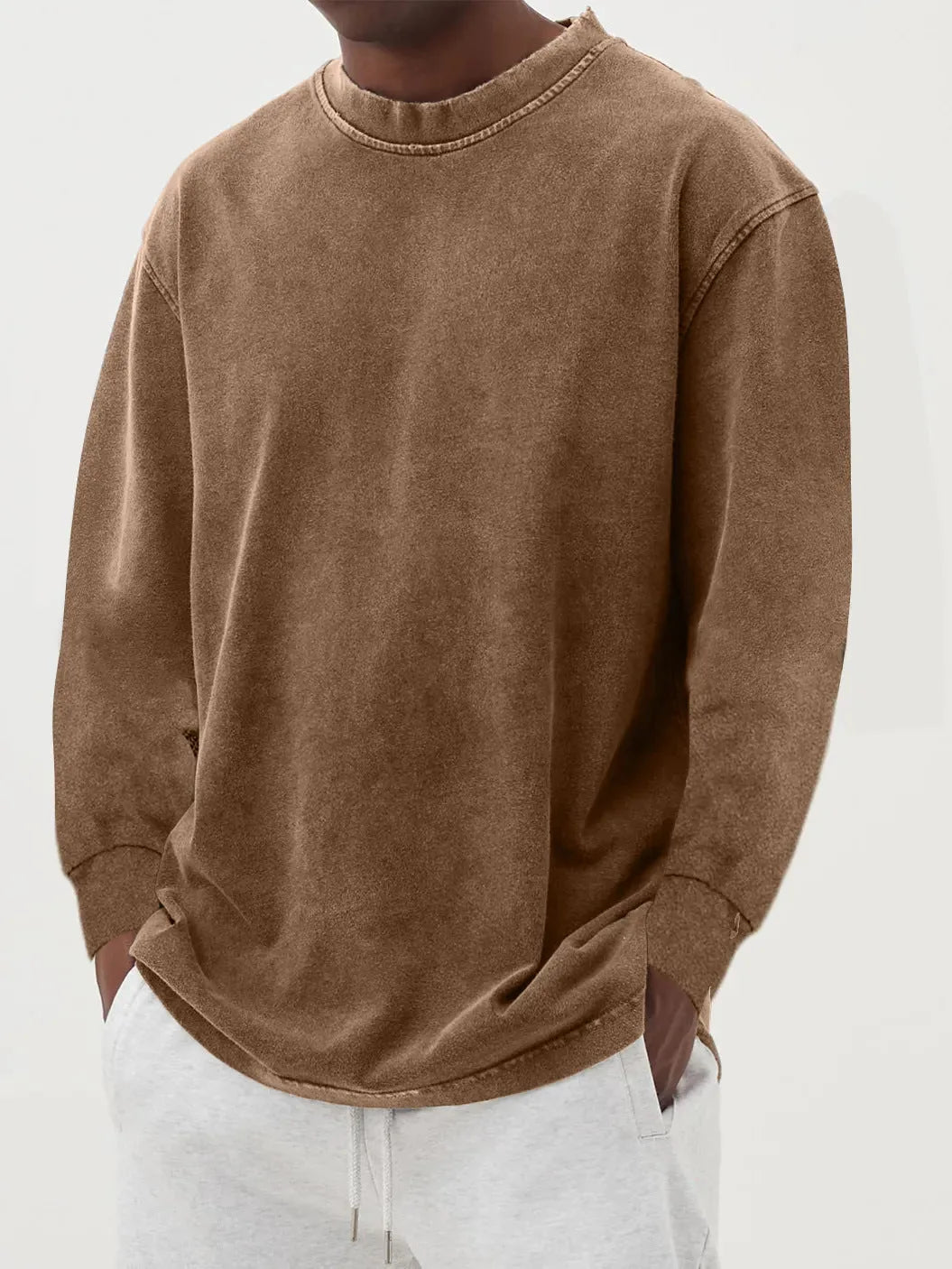 Side-angled view of the dark blue washed jumper showing the loose drape and curved hem