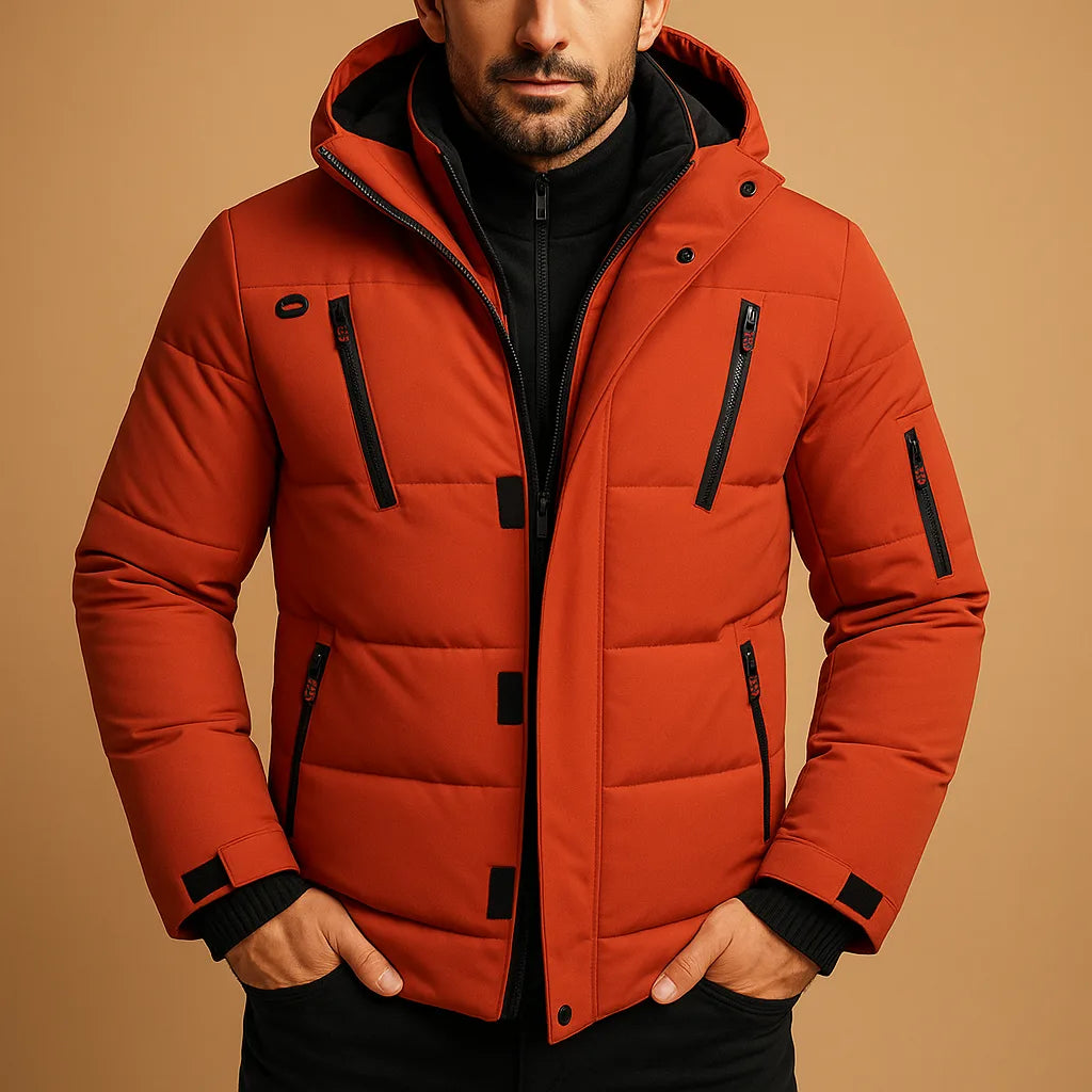 Close-up of an orange quilted puffer jacket showing hood lining, chest zip pockets and sleeve pocket detail.