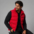 Close-up of the stand collar and zip closure on a black padded gilet against a plain backdrop