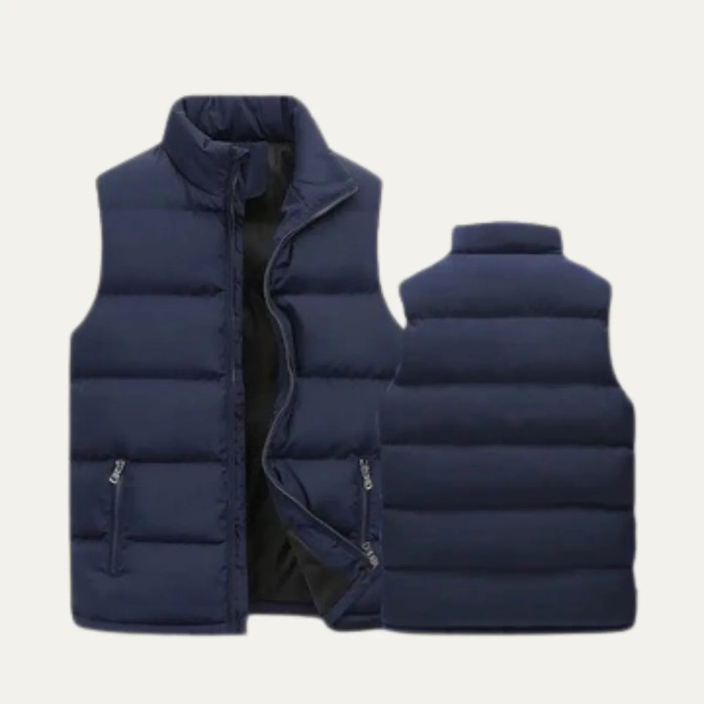 Close-up front view of a black padded gilet highlighting the metal zip pull and pocket stitching