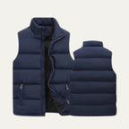 Close-up front view of a black padded gilet highlighting the metal zip pull and pocket stitching