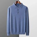 Detail shot of the button placket on the white polo jumper against a dark grey surface