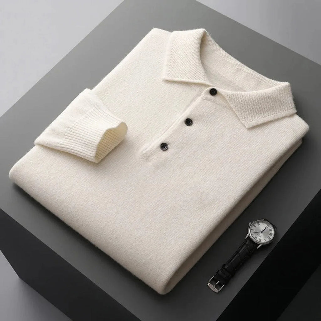 Folded ivory white cashmere polo jumper showing ribbed cuff and three-button placket up close