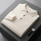 Folded ivory white cashmere polo jumper showing ribbed cuff and three-button placket up close