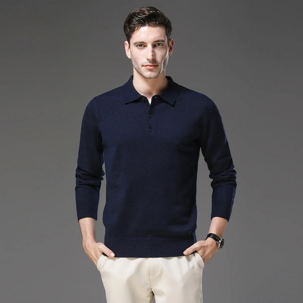 Man wearing a navy polo neck jumper with long sleeves and ribbed hem, hands in pockets