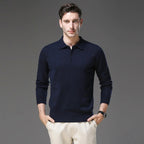 Man wearing a navy polo neck jumper with long sleeves and ribbed hem, hands in pockets
