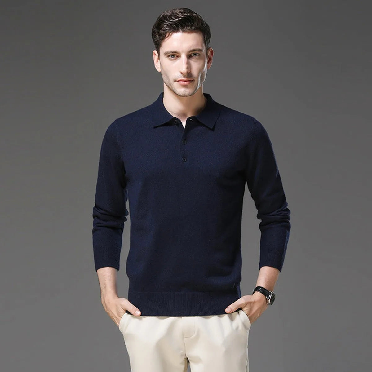 Man wearing a navy polo neck jumper with long sleeves and ribbed hem, hands in pockets