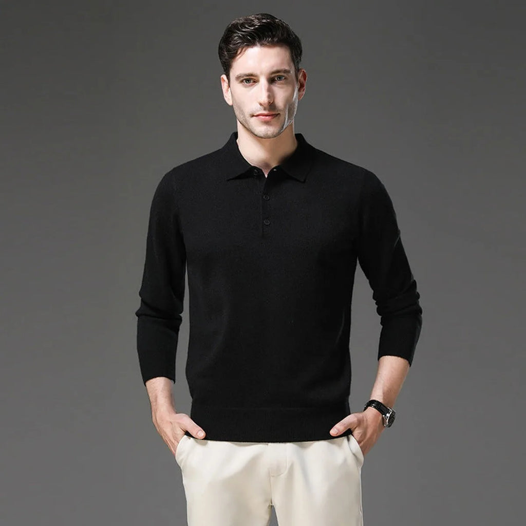 Man wearing a black polo neck jumper with collar and buttons, paired with cream trousers