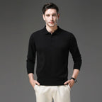 Man wearing a black polo neck jumper with collar and buttons, paired with cream trousers