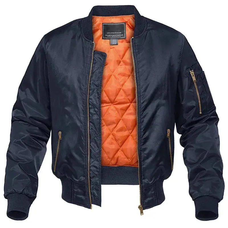 Navy quilted bomber jacket with front zip open, showing bright orange diamond-quilted lining and ribbed collar.