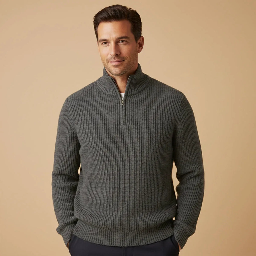 Man wearing charcoal grey ribbed half-zip jumper with navy trousers, front view