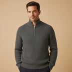 Man wearing charcoal grey ribbed half-zip jumper with navy trousers, front view