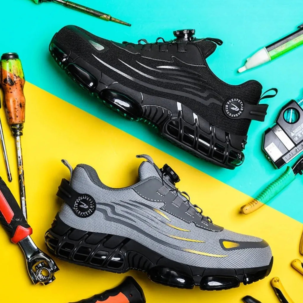 Pair of safety trainers, one black and one grey, laid diagonally on a teal and yellow background surrounded by work tools