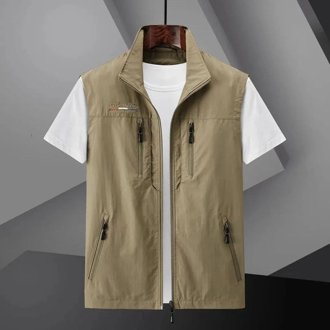 Khaki sleeveless zip-up gilet with stand collar and zip pockets, laid out open over a white t-shirt on a hanger
