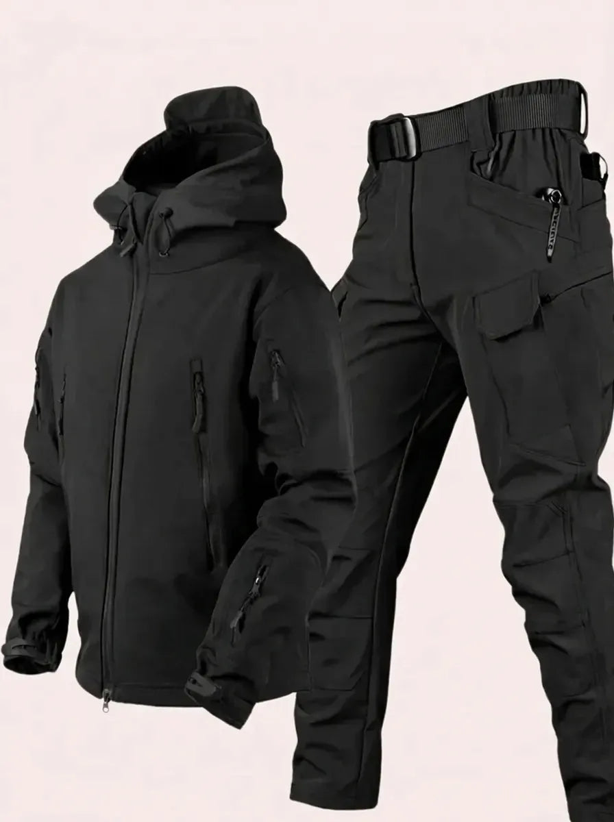 Black hooded softshell jacket and cargo trousers with belt displayed flat, showing full set construction