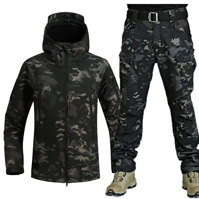 Dark camo softshell jacket paired with matching trousers, worn with tan boots for a full tactical look
