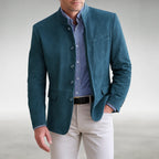 Close-up front view of a teal suede mandarin collar jacket worn open over a striped shirt