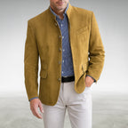 Close-up front view of a mustard yellow suede mandarin collar jacket buttoned over a striped shirt