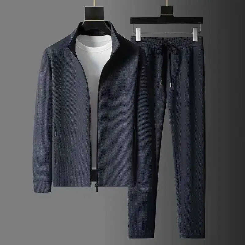 Front view of grey textured zip-up jacket with stand collar worn open over a white t-shirt on a hanger
