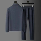 Back view of grey textured tracksuit jacket and matching trousers displayed together on hangers