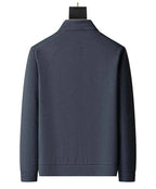 Back view of grey textured zip-up jacket showing stand collar and ribbed cuffs on plain background
