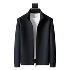Front view of black textured zip-up jacket with stand collar worn open over a white t-shirt