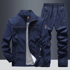 Navy blue tracksuit jacket and matching joggers, front view showing stand collar and zip pockets