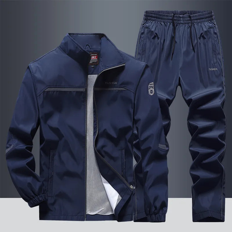 Navy blue tracksuit jacket and matching joggers, front view showing stand collar and zip pockets